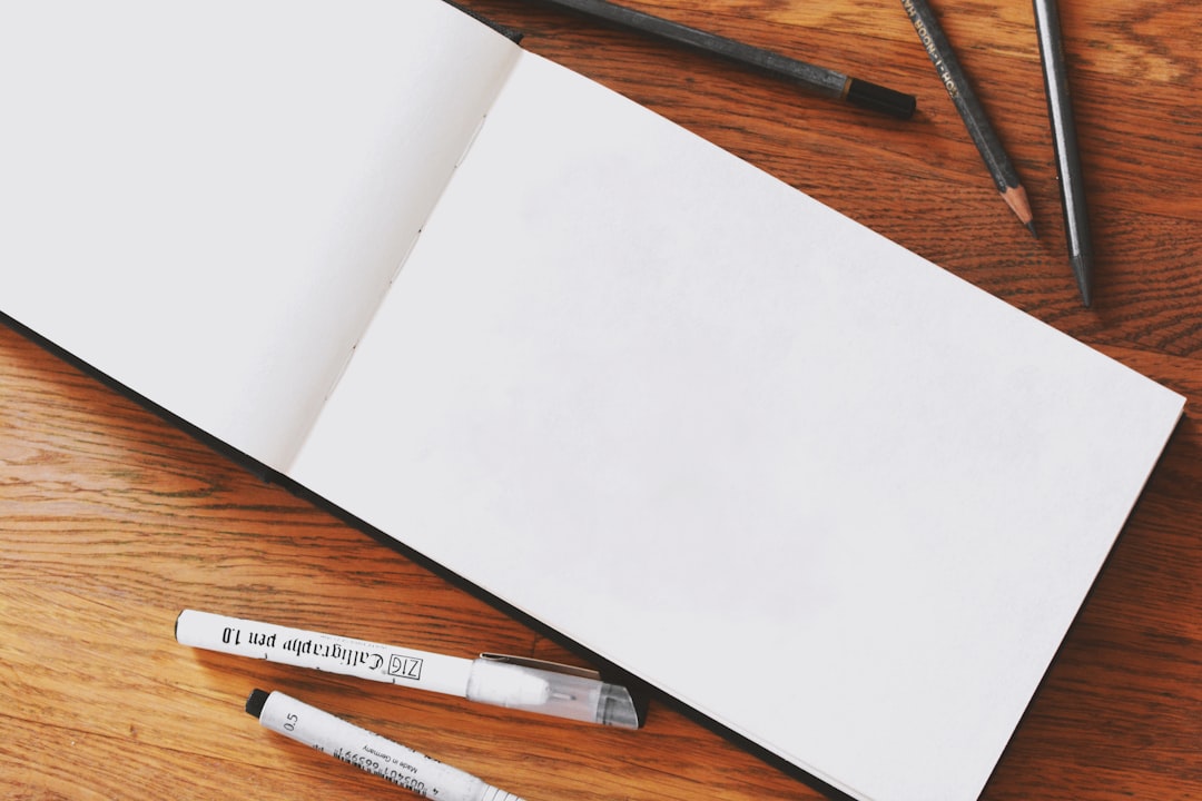 Minimal creative workspace with paper and design tools
